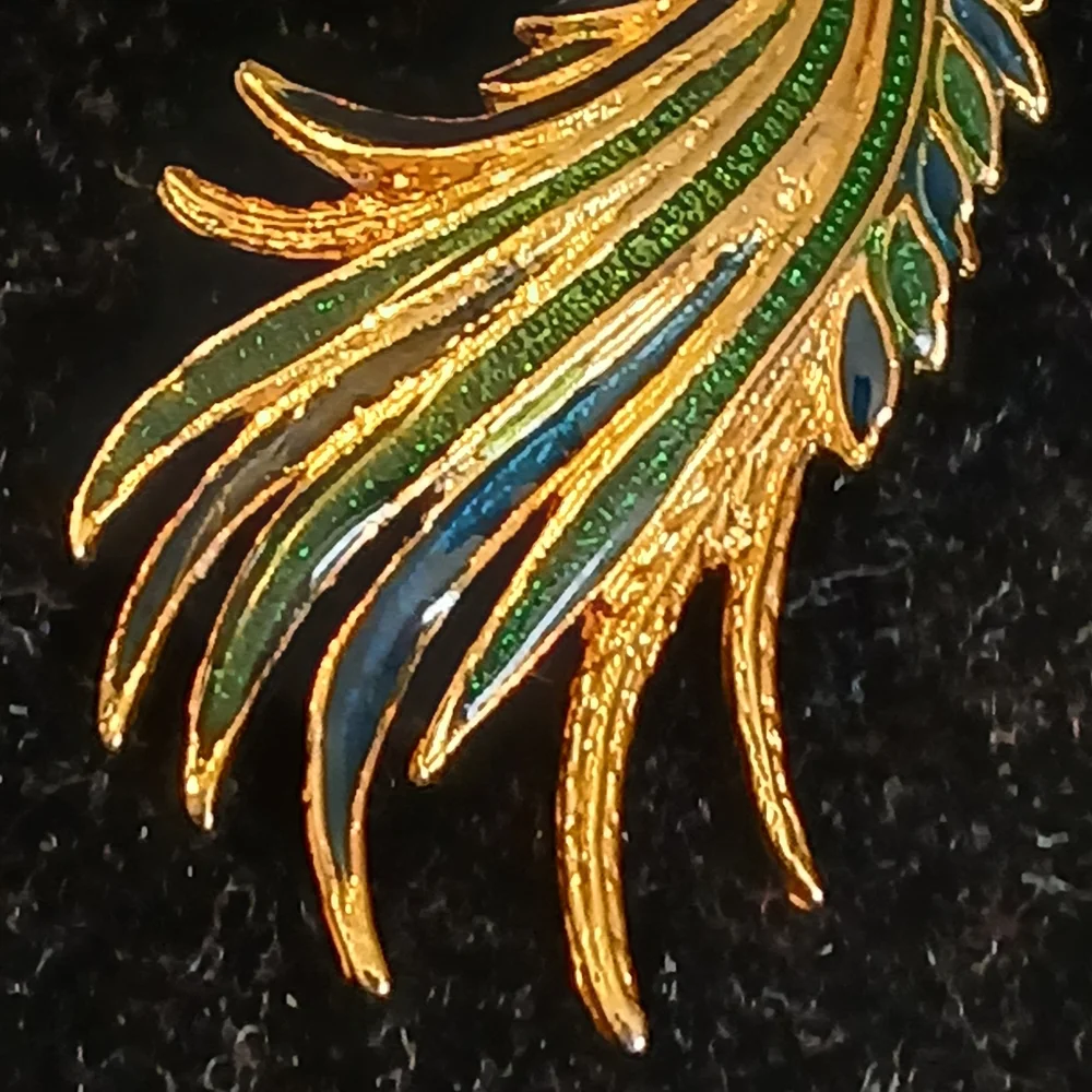 Goldtone peacock brooch with blue and green accents
